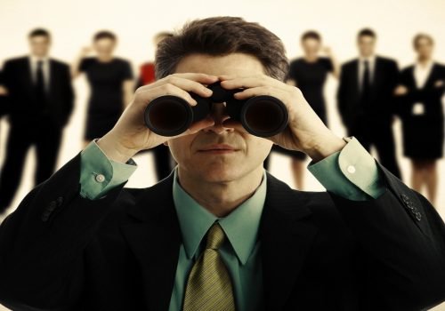 Businessman with binoculars. Businessman with binoculars.